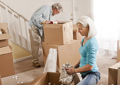older couple packing up moving boxes